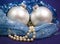 Beautiful silvery New Year`s ball, brilliant tinsel and a pearl beads on a blue background - New Year`s composition, a card