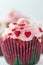 Beautiful single cupcake with icing and little red heart candy