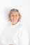 Beautiful sixty year old blonde mature woman warm wool sweater on white background