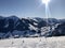 Beautiful ski panorama: Ski slope with ski lifts chairlifts and unidentifiable skiers