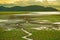 Beautiful sky during sunset, Cracked ground with small green grass and little water flow leading to river