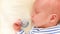 Beautiful sleeping baby Close-up portrait Dolly shot of the hand on a newborn baby face shallow depth of field