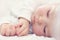 Beautiful sleeping newborn baby on white