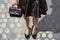 Beautiful slender women\\\'s legs, luxury handbag, skirt