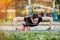 Beautiful slim brunette doing some Push-Ups outside in Park. Fitness woman during outdoor cross training workout