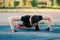 Beautiful slim brunette doing some Push-Ups outside in Park. Fitness woman during outdoor cross training workout