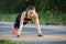 Beautiful slim brunette doing some Push-Ups outside in Park. Fitness woman during outdoor cross training workout