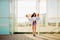 Beautiful slim girl in short shorts standing with a longboard in his hand