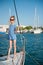 Beautiful slim little girl in a striped shirt and sunglasses on luxury yacht in summer day