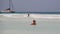 Beautiful Slim Woman in Red Swimsuit Bathes and Rests in Ocean on Paradise Beach