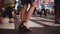 Beautiful slow motion shot of young female freelancer crossing a busy crowded street at night in Times Square, New York.