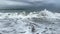 Beautiful slow motion waves crashing on sandy shore. Ocean power. Water rolling on sand on a beach. Element aqua. Film