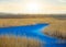 Beautiful small blue river flow among a prairie