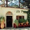 Beautiful small greek chapel with flower pots (Crete, Greece)