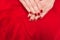 Beautiful small red female fingers on red fabric texture