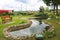 Beautiful small small pond stone natural homemade in nature. Landscaping with artificial pond