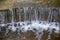 Beautiful small waterfall with cascades in Reina Sofia Park, Guardamar del Segura. Valencia, Spain.