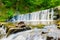 Beautiful small waterfall on nice creek in forest