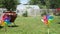 Beautiful small weather vanes in green grass house garden with ceramic decoration. Colorfull mill and watering plants in a sunny d