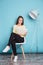 Beautiful smart young woman reading book sitting on the chair