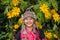 Beautiful smile young hill tribe girl in sunflowers garden.