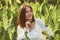 Beautiful smilimg brunette girl posing in fern