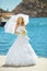 Beautiful smiling bride girl in wedding dress with white umbrell