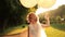 Beautiful smiling bride walking with balloons in the autumn park