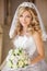 Beautiful smiling bride woman with bouquet of flowers, wedding m