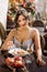 Beautiful smiling brunette girl having lunch in a street cafe, sitting at a table and eating Italian pasta. Advertising,