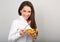 Beautiful smiling business woman eating healthy organic vegatable salad on the lunch on blue background with empty copy space.