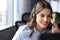 Beautiful smiling call center worker in headphones is working at modern office