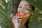 Beautiful smiling Caucasian Woman with fresh fruit Papaya (outdoors)