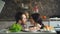 Beautiful smiling couple play and kiss above the table with vegetables while cooking in kitchen