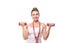 Beautiful smiling female coach holds a red dumbbells in hands and shows muscular arms, isolated on white. Caucasian