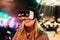 Beautiful smiling female experiencing unbelievable feelings with VR glasses