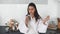 Beautiful smiling girl dressed in white bathrobe preparing breakfast.