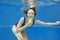 Beautiful smiling girl eating yellow ice cream underwater