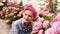 Beautiful smiling girl in the garden of hydrangea. Large hydrangea flowers in her hands. Beautiful young woman gardening