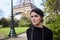 Beautiful smiling girl posing on the background of the Eiffel Tower. Paris, Champ de Mars