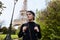 Beautiful smiling girl posing on the background of the Eiffel Tower. Paris, Champ de Mars