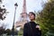 Beautiful smiling girl posing on the background of the Eiffel Tower. Paris, Champ de Mars