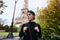 Beautiful smiling girl posing on the background of the Eiffel Tower. Paris, Champ de Mars