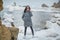 Beautiful smiling girl at sea on the rocks winter