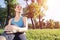 Beautiful smiling girl in sportswear relax in park