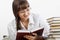 Beautiful Smiling girl thoughtfully reading a book