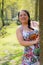 Beautiful smiling Mexican woman next to a tree trunk