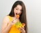 Beautiful smiling positive woman eating healthy organic vegatable salad in yellow bright clothing on blue background. Closeup