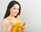 Beautiful smiling positive woman eating healthy organic vegatable salad in yellow bright clothing on blue background. Closeup