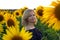 Beautiful smiling woman in the field with sunflowers